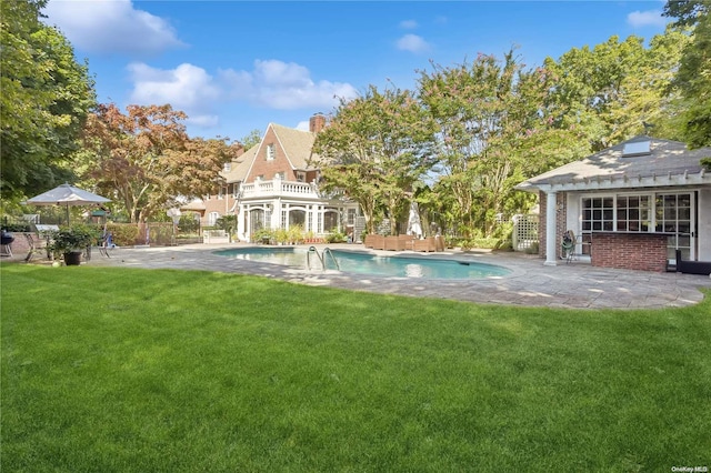 view of pool with a yard and a patio