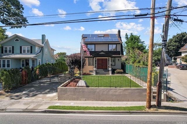 view of property with a front lawn and solar panels