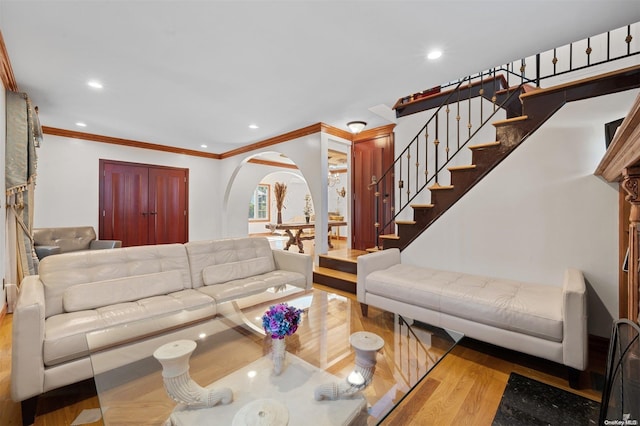 living room with hardwood / wood-style floors and crown molding