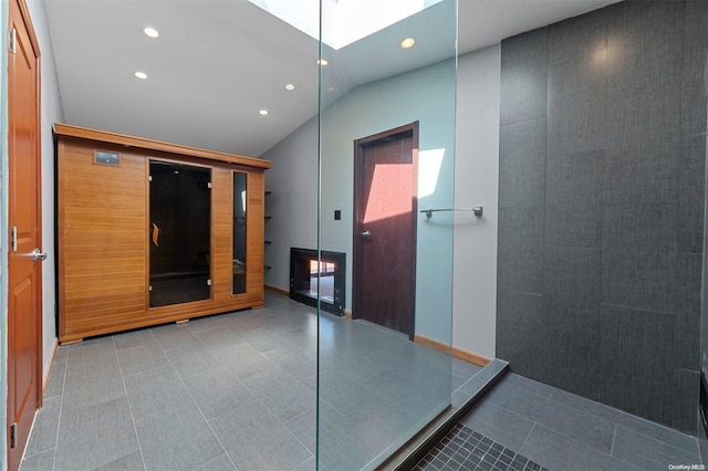 corridor featuring lofted ceiling with skylight