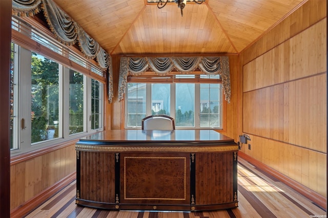 office space featuring wooden walls, wooden ceiling, lofted ceiling, and light wood-type flooring