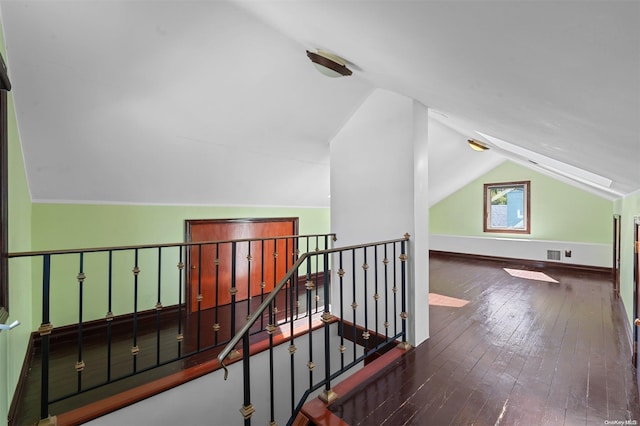 additional living space with dark hardwood / wood-style floors and vaulted ceiling