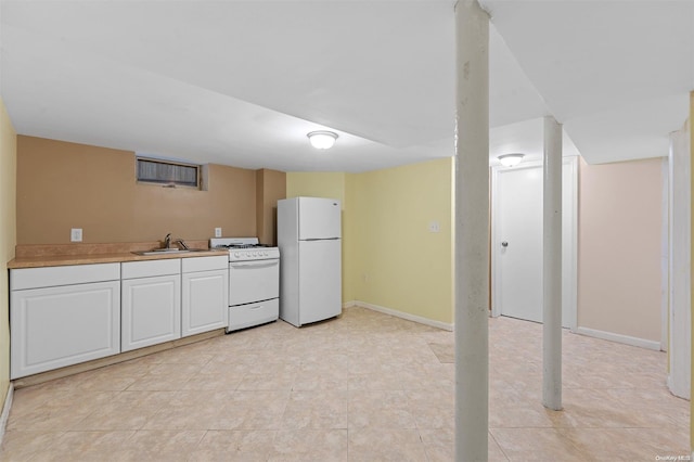 kitchen featuring sink, white cabinets, white appliances, and light tile patterned floors