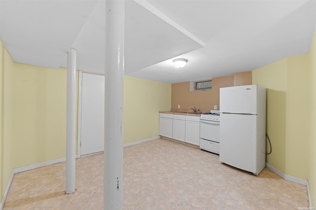 kitchen featuring sink, white cabinets, and white appliances