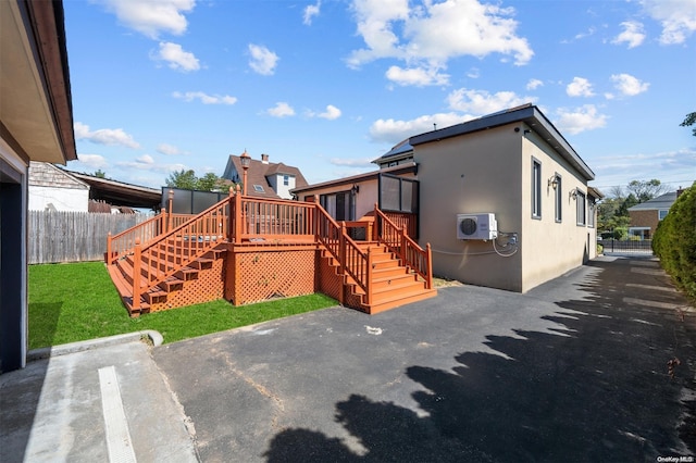 back of property with a patio area, a yard, and a deck