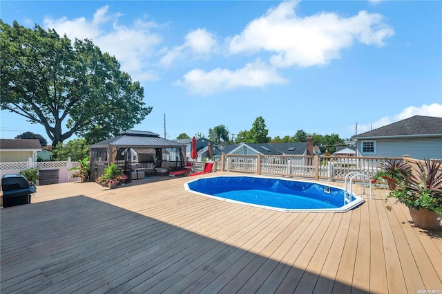 view of pool with a gazebo and a deck