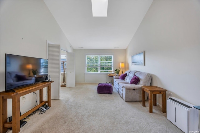 living room featuring light carpet and high vaulted ceiling