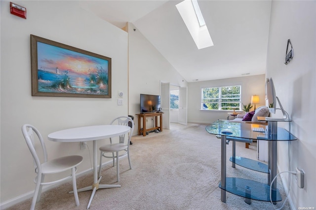 living room with light carpet, high vaulted ceiling, and a skylight