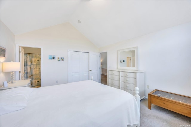 bedroom with light carpet, high vaulted ceiling, and a closet