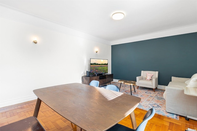 dining room featuring parquet floors and crown molding