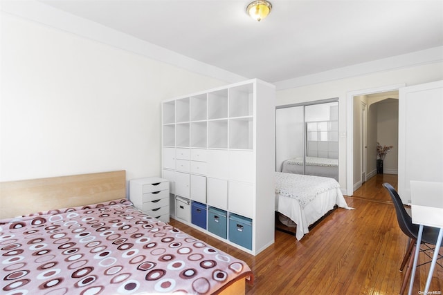 bedroom with hardwood / wood-style floors and a closet