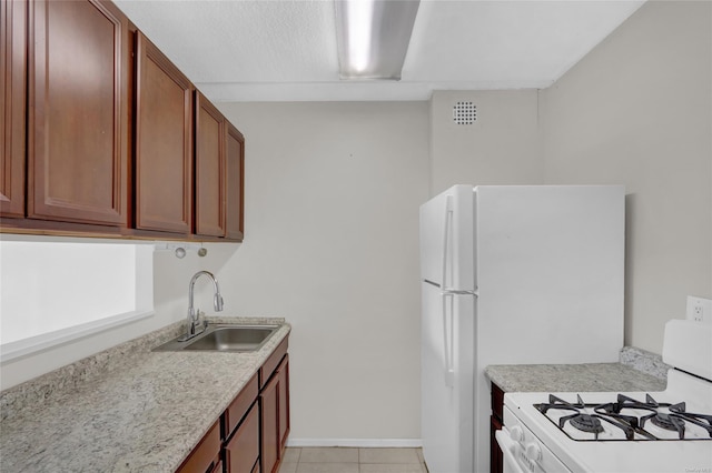 135 Post Ave Unit 6L, Westbury, NY 11590 - kitchen with gas range gas stove, a sink, light countertops, light tile patterned floors, and baseboards