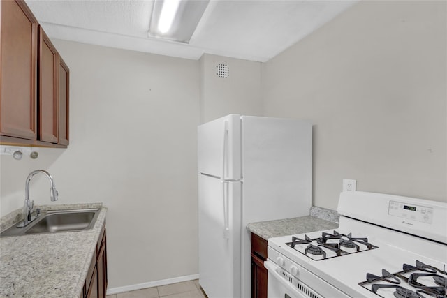 135 Post Ave Unit 6L, Westbury, NY 11590 - kitchen with white appliances, a sink, light countertops, light tile patterned floors, and baseboards