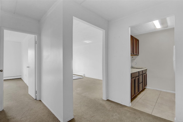 135 Post Ave Unit 6L, Westbury, NY 11590 - corridor featuring baseboard heating, a sink, light carpet, ornamental molding, and light tile patterned flooring