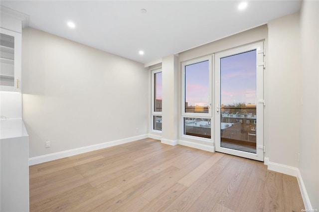 unfurnished room with light wood-type flooring