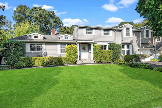 view of front of house featuring a garage and a front yard