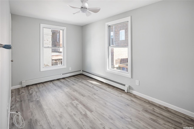 empty room with ceiling fan, a healthy amount of sunlight, and light hardwood / wood-style floors