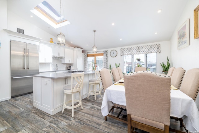 3461 Ocean Ave, Oceanside, NY 11572 - dining room with a skylight, lofted ceiling, dark wood finished floors, and recessed lighting