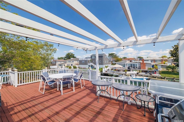 3461 Ocean Ave, Oceanside, NY 11572 - wooden deck featuring outdoor dining area, a pergola, a residential view, and a water view