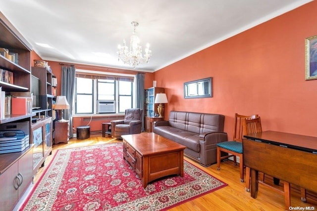 living room featuring a notable chandelier, cooling unit, and light hardwood / wood-style flooring