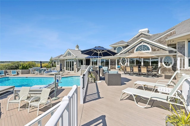 view of swimming pool featuring a wooden deck