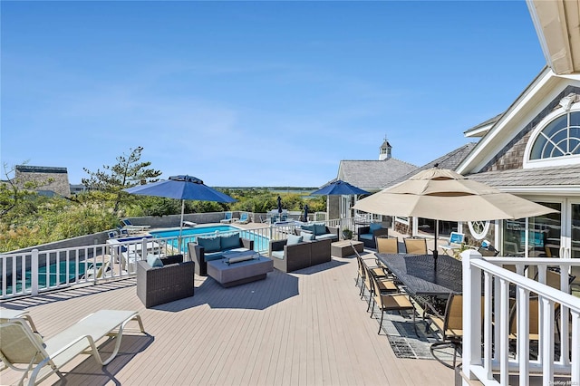 wooden deck featuring a fenced in pool and an outdoor hangout area