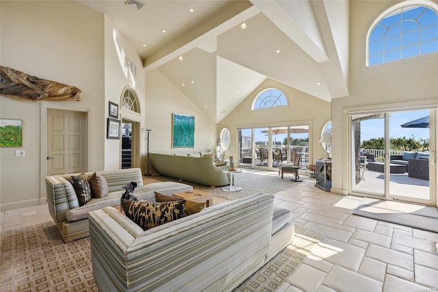 living room with beam ceiling and high vaulted ceiling