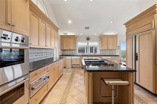 kitchen featuring a center island, paneled appliances, dark stone countertops, and backsplash