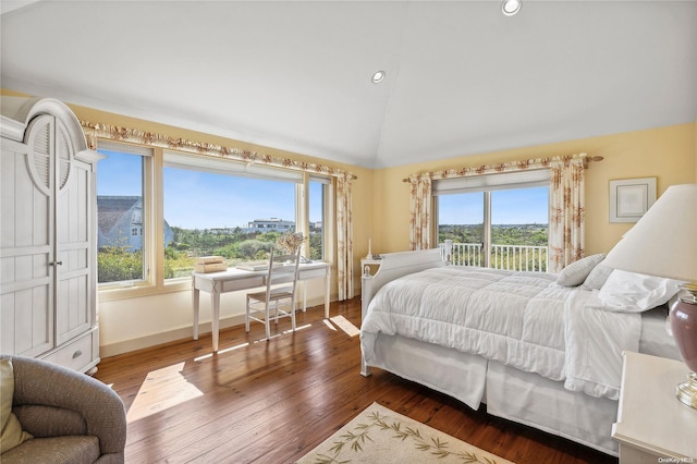 bedroom with dark hardwood / wood-style floors, lofted ceiling, and multiple windows