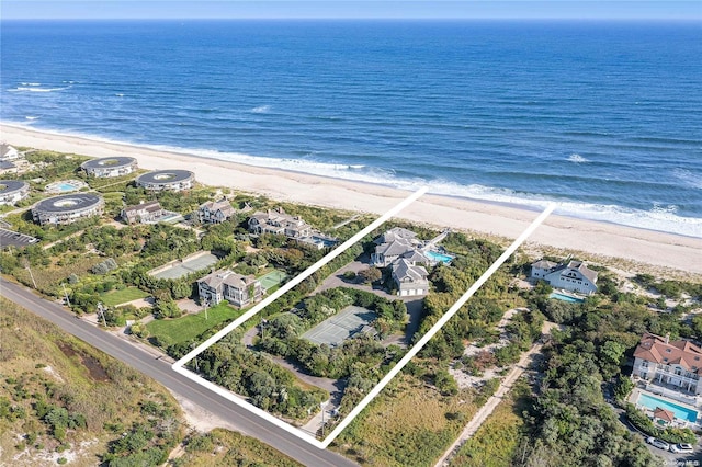 aerial view with a water view and a beach view