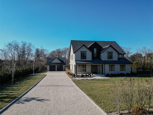 view of front of house with a garage and a front yard