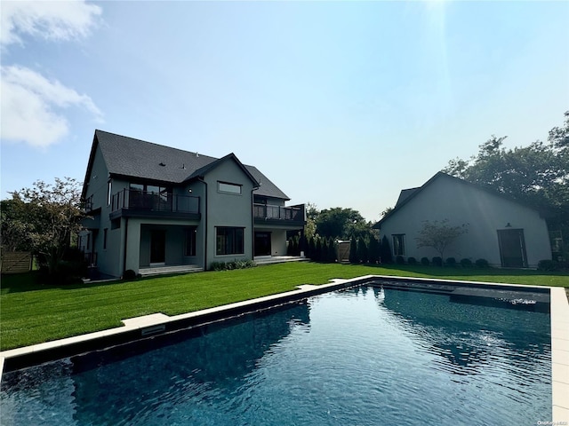 view of pool featuring a lawn