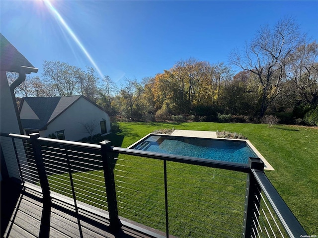 view of pool with a yard