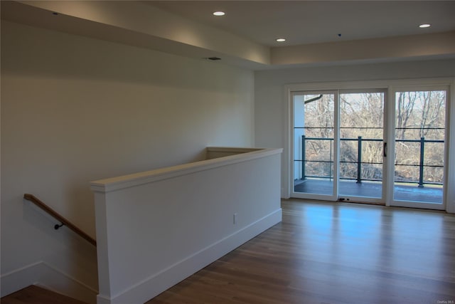 empty room with dark hardwood / wood-style flooring