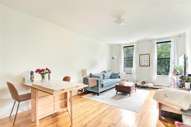 living room with hardwood / wood-style flooring and baseboard heating