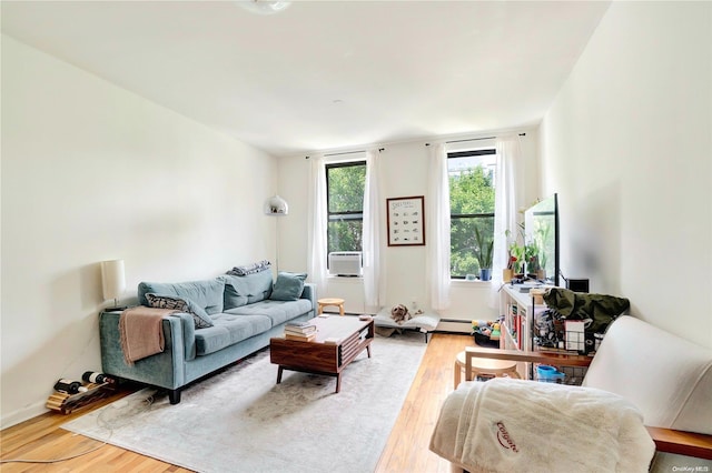 living room featuring light hardwood / wood-style floors, a baseboard radiator, and cooling unit