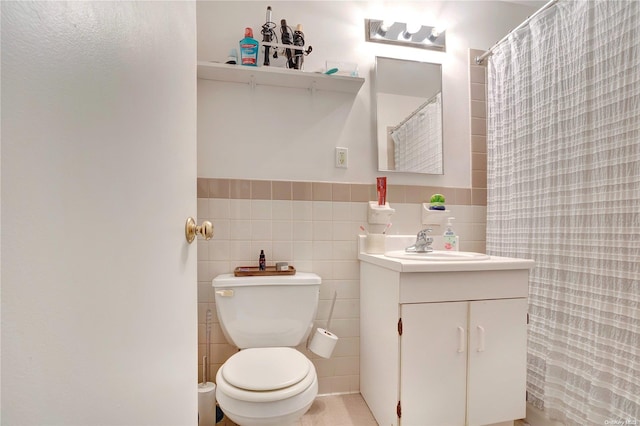 bathroom with vanity, tile walls, and toilet