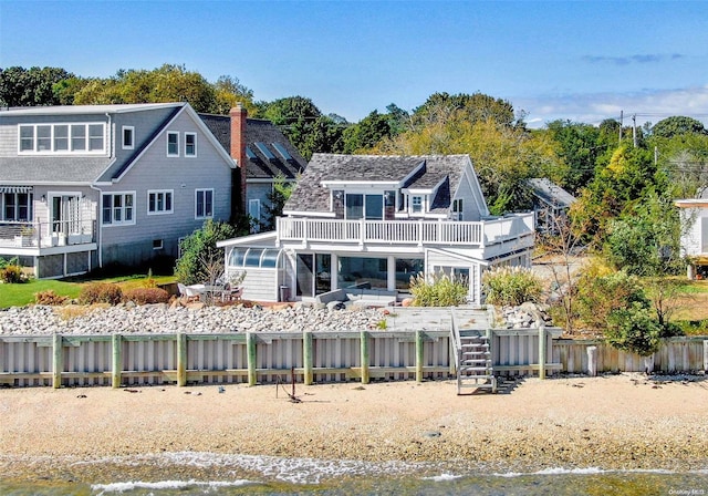 back of property with a balcony and a deck