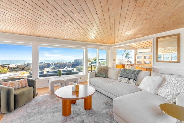 living room with wood-type flooring, a water view, a wall unit AC, and wooden ceiling