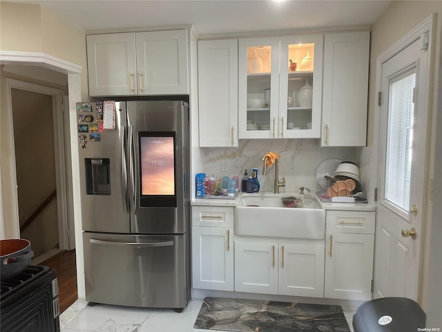 kitchen with white cabinetry, backsplash, and stainless steel fridge with ice dispenser