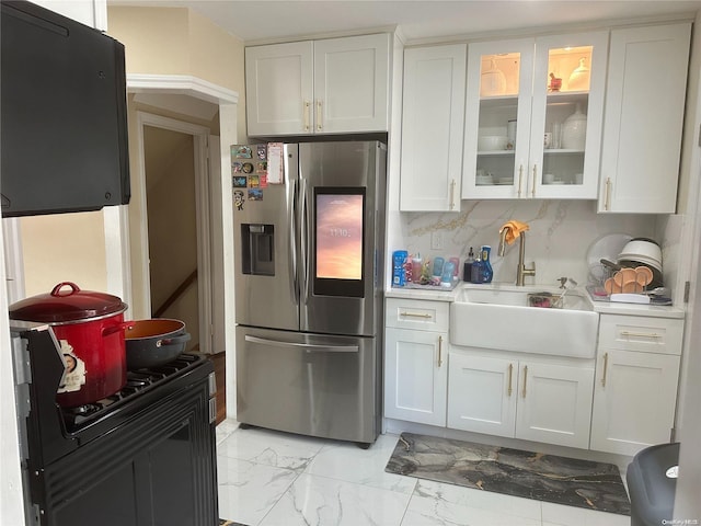 kitchen with white cabinetry, stainless steel fridge with ice dispenser, sink, and tasteful backsplash