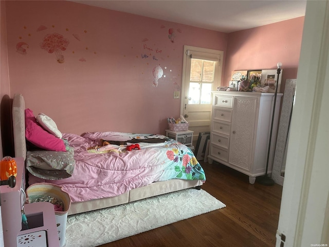 bedroom with dark wood-type flooring