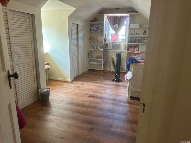 bonus room with cooling unit, wood-type flooring, and lofted ceiling