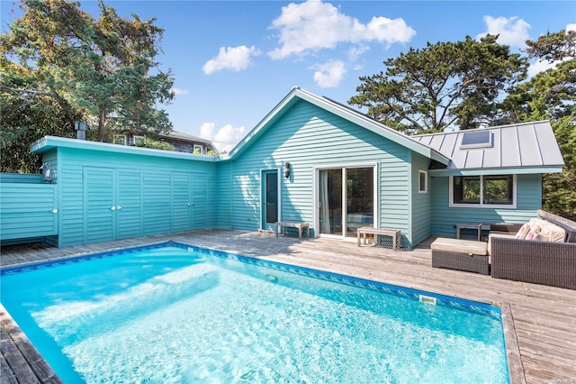 view of pool with an outdoor living space and a wooden deck