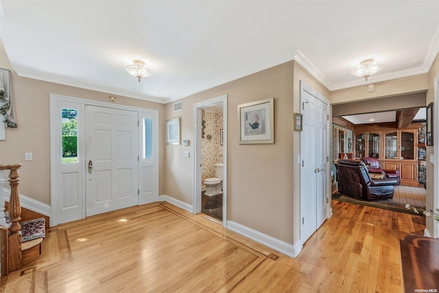 entrance foyer featuring light hardwood / wood-style flooring and ornamental molding