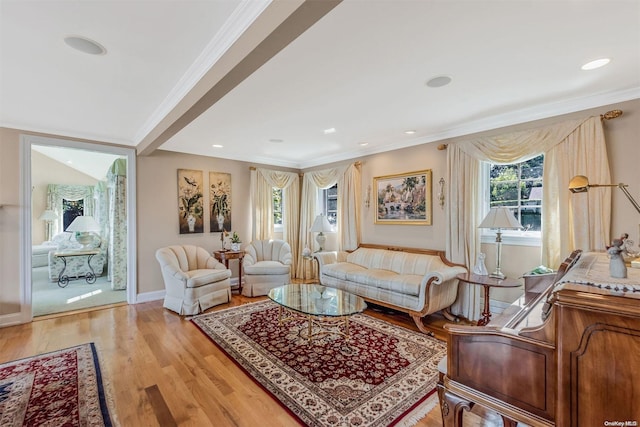 living room with light hardwood / wood-style flooring and ornamental molding