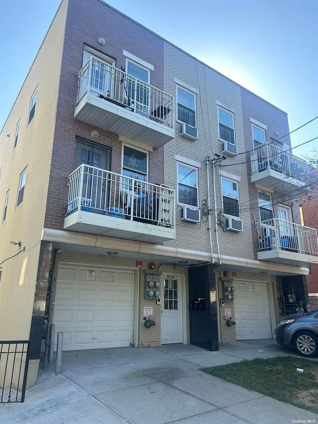 view of front of home featuring a garage and cooling unit