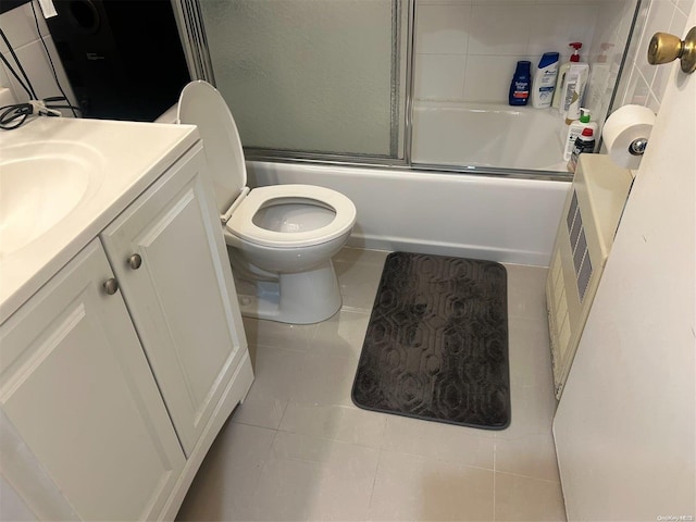 full bathroom featuring tile patterned floors, vanity, toilet, and shower / bath combination with glass door