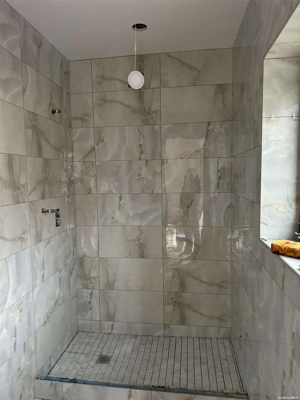 bathroom with a tile shower