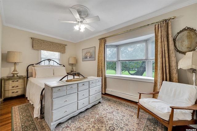 bedroom featuring ceiling fan, crown molding, a baseboard radiator, and light hardwood / wood-style flooring